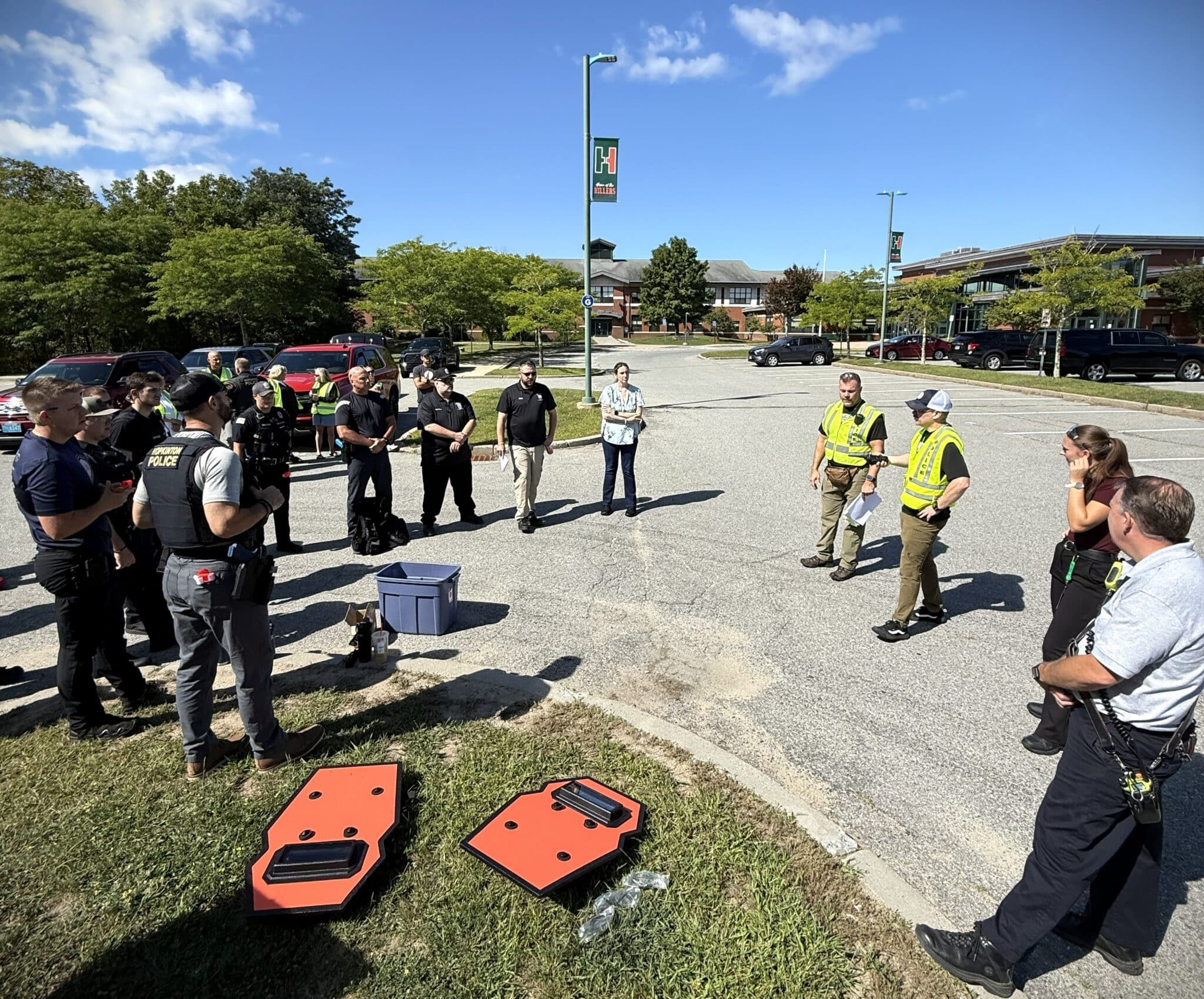 Hopkinton police officers and firefighters reviewed their response after completing their first simulated emergency scenario during Saturday's joint training exercise.