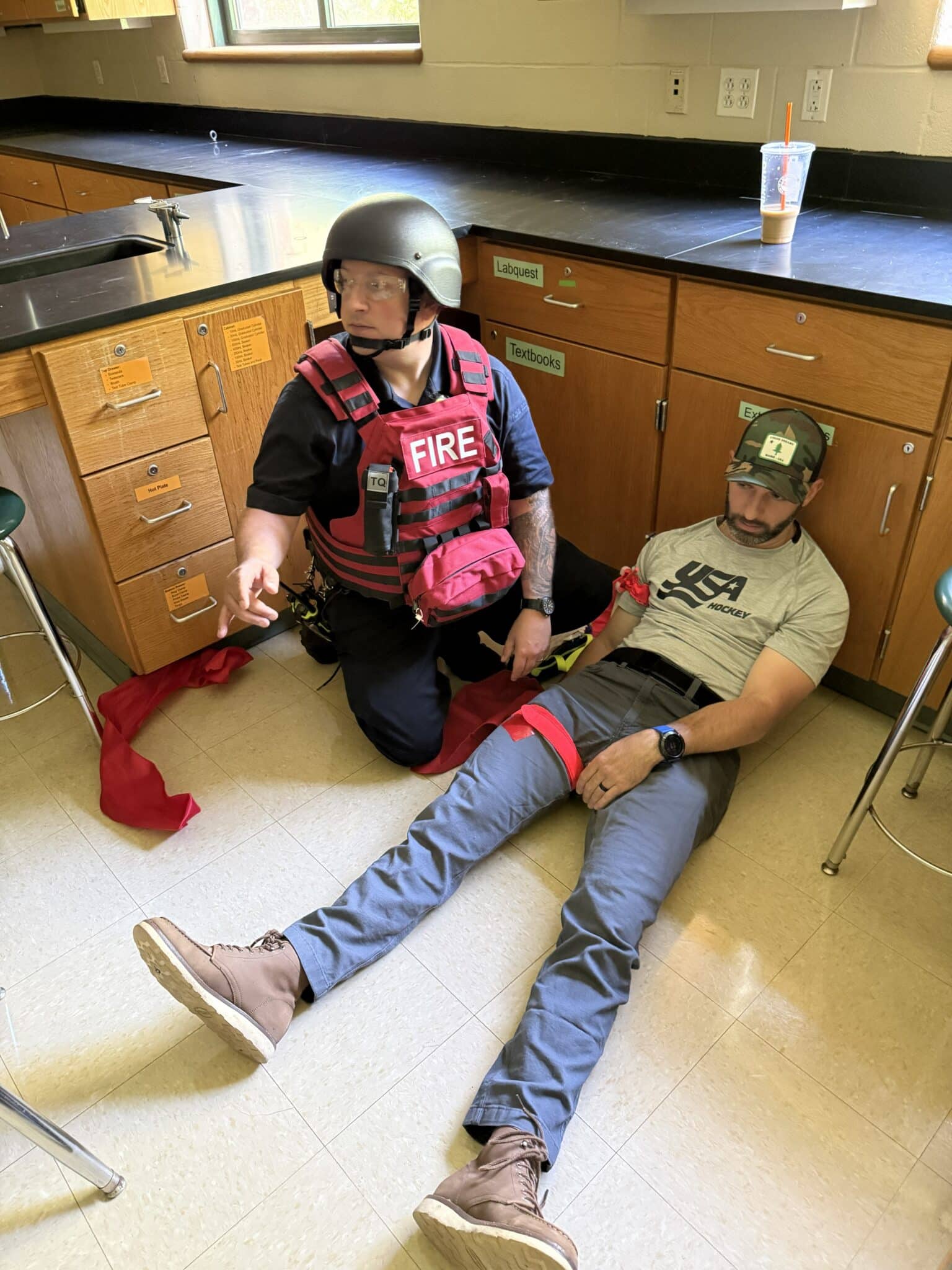 A Hopkinton firefighter provided treatment to a police officer posing as a wounded victim during an active-shooter training drill held at Hopkinton High School on Saturday.
