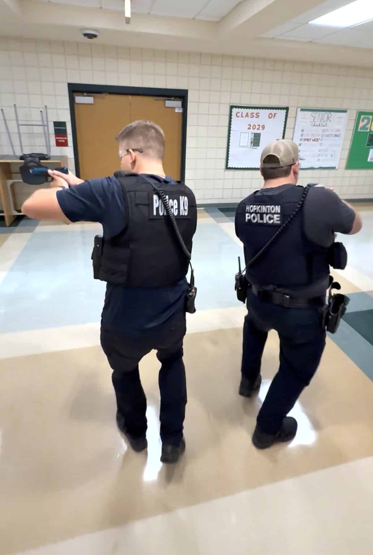 Two Hopkinton police officers clear a hallway during an active-shooter training exercise held on Saturday at Hopkinton High School.